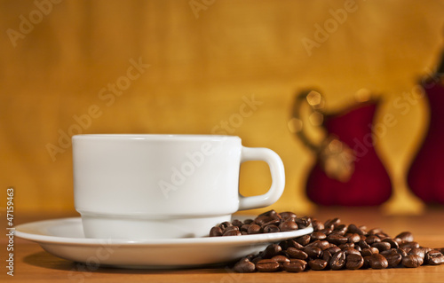 White cup of coffee on a yellow background