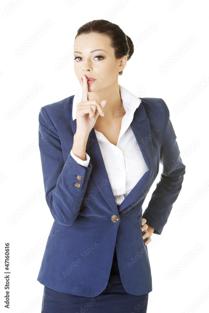Attractive business woman with finger on lips Attractive business woman with finger on lips