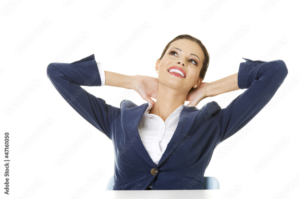 Female executive relaxing with hands behind head Female executive relaxing with hands behind head