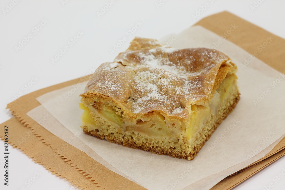 Slice of an apple pie on a baking paper Slice of an apple pie on a baking paper