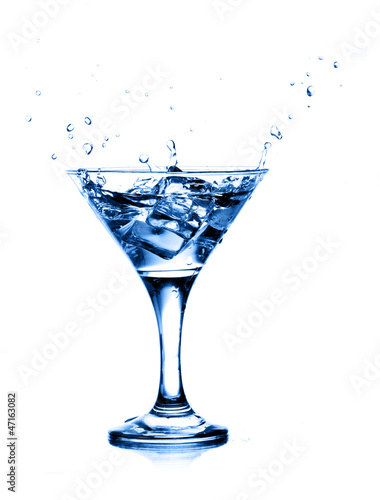 splashing into a martini isolated on white background