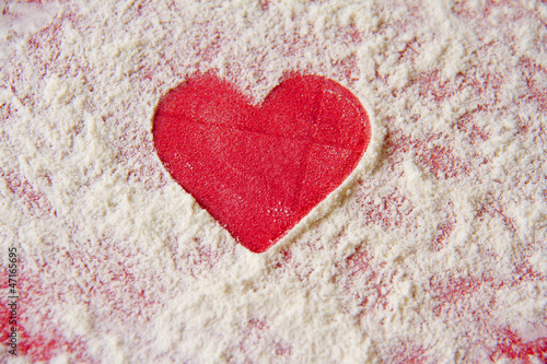 Simple red heart shape cutout in flour