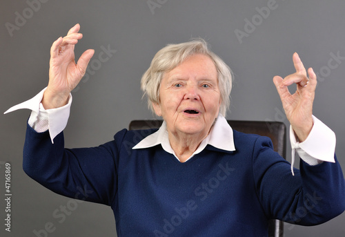 Obraz na płótnie Senior happy woman with grey hairs against grey background. w salonie