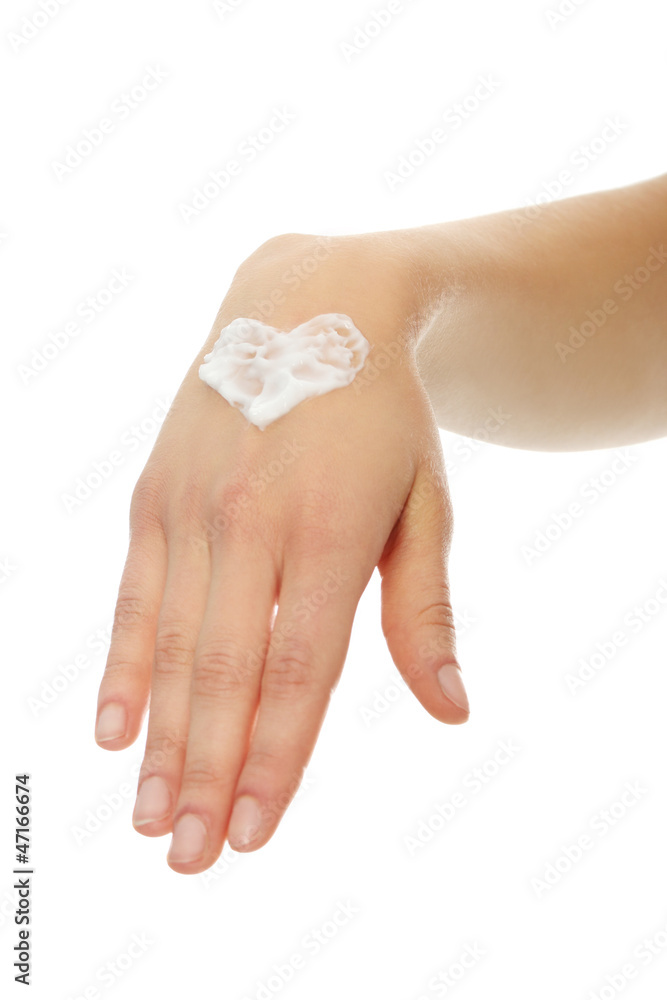 Fototapeta premium Beautiful female hand applying hand cream