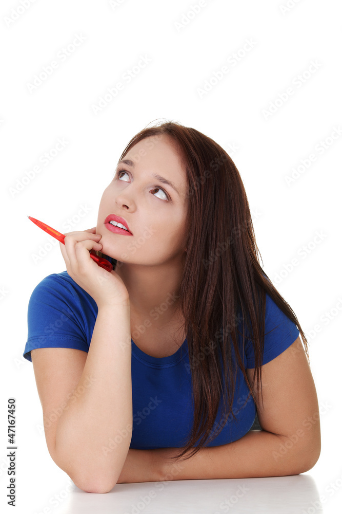 Student woman sitting at the desk and thinking Student woman sitting at the desk and thinking