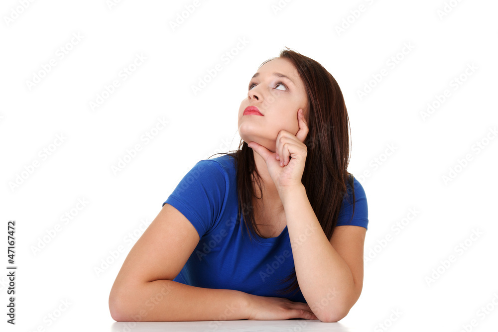 Student woman sitting at the desk and thinking Student woman sitting at the desk and thinking
