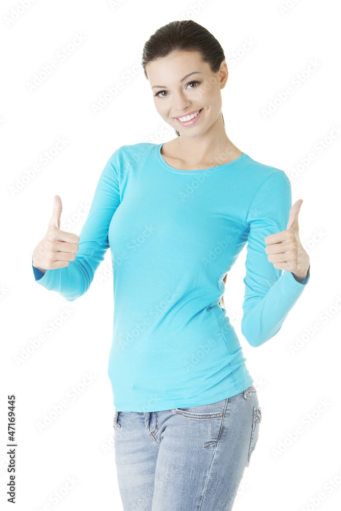 Beautiful young woman gesturing thumbs up. Beautiful young woman gesturing thumbs up.