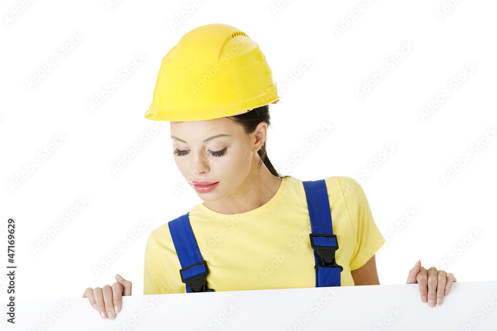 Female construction worker with blank board Female construction worker with blank board