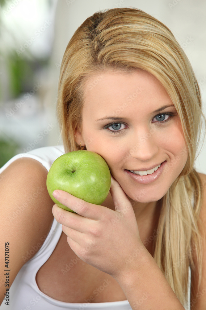 beautiful blonde woman and an apple beautiful blonde woman and an apple