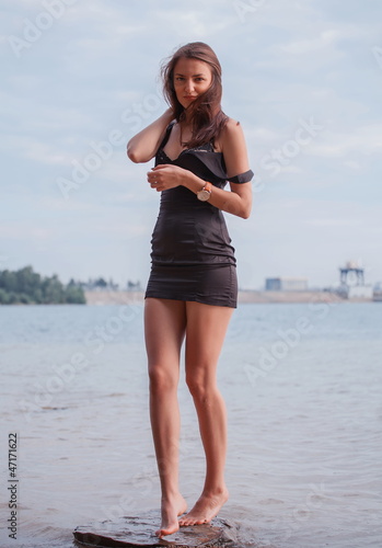 Fashionable woman by lake