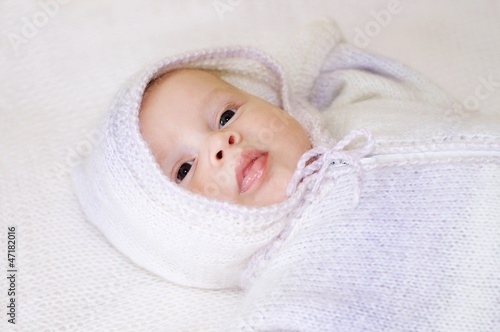 Portrait of baby in a knitted suit with a hood (2 months)