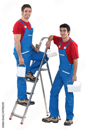 Two male decorators wearing matching outfits