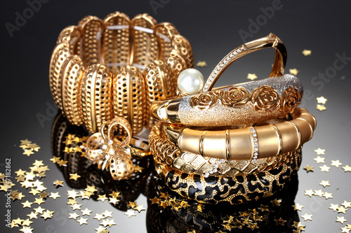 Beautiful golden jewelry on grey background photo