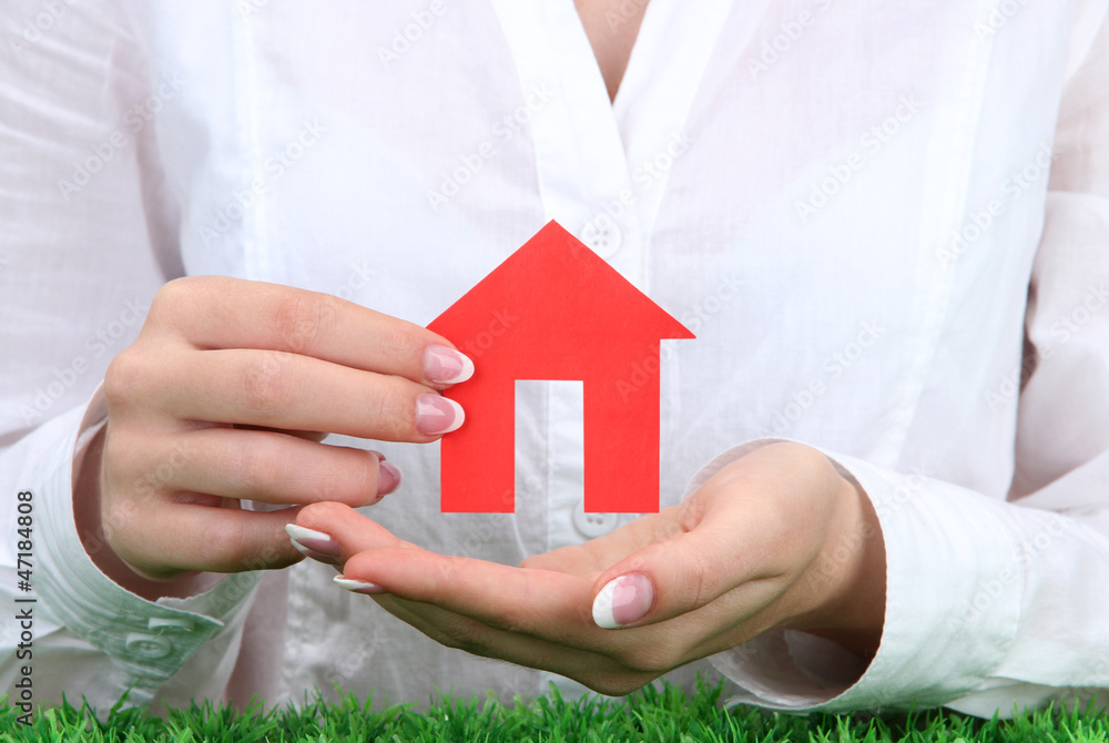 concept: woman hands with paper house, close up concept: woman hands with paper house, close up