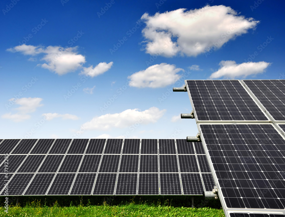 Solar energy panels against blue sky with clouds Solar energy panels against blue sky with clouds