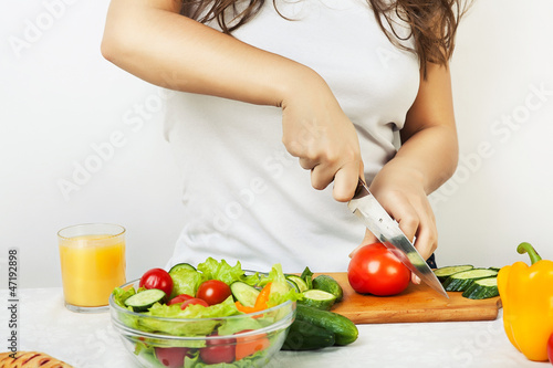 woman cutting tomato