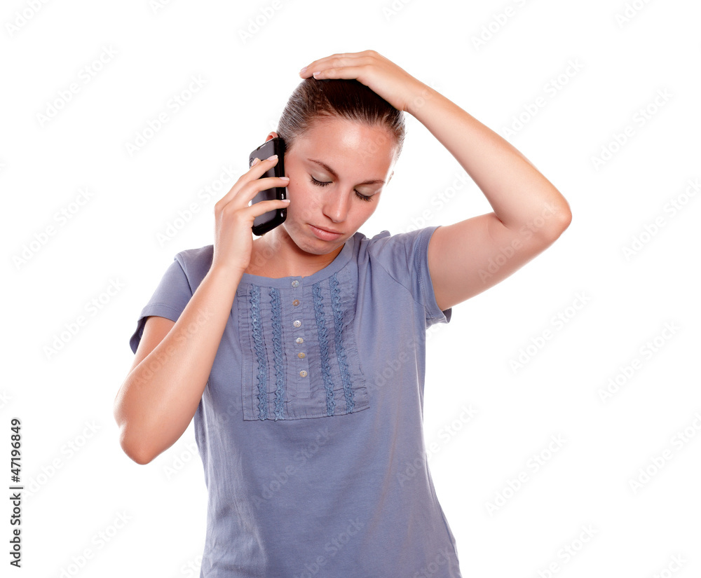 Stressed young woman conversing on cellphone Stressed young woman conversing on cellphone