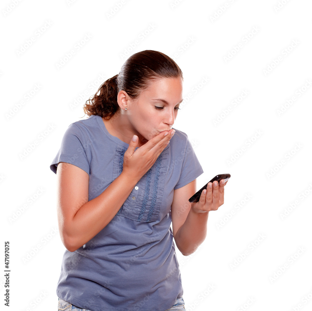Stylish young woman sending a kiss by cellphone Stylish young woman sending a kiss by cellphone