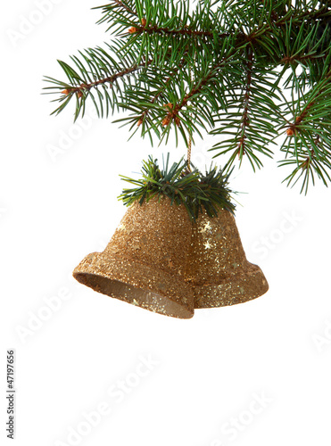 Two bells hanging on a spruce on white background