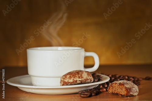 White cup of coffee and cakes on a plate