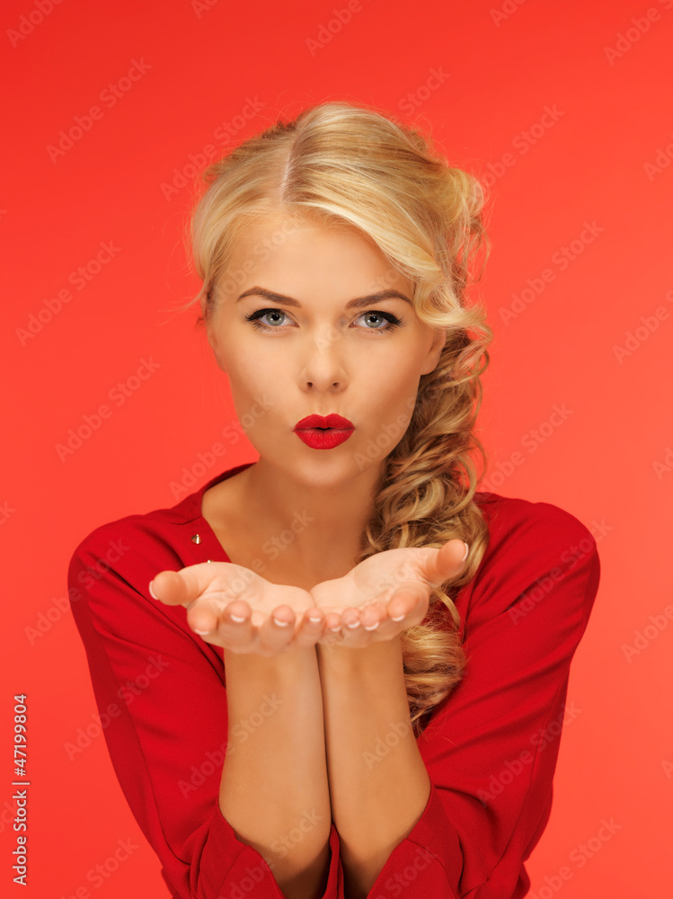 woman blowing something on the palms of her hands woman blowing something on the palms of her hands