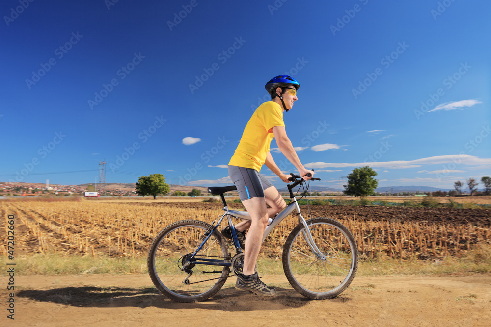 Biker in yellow shirt riding a bike