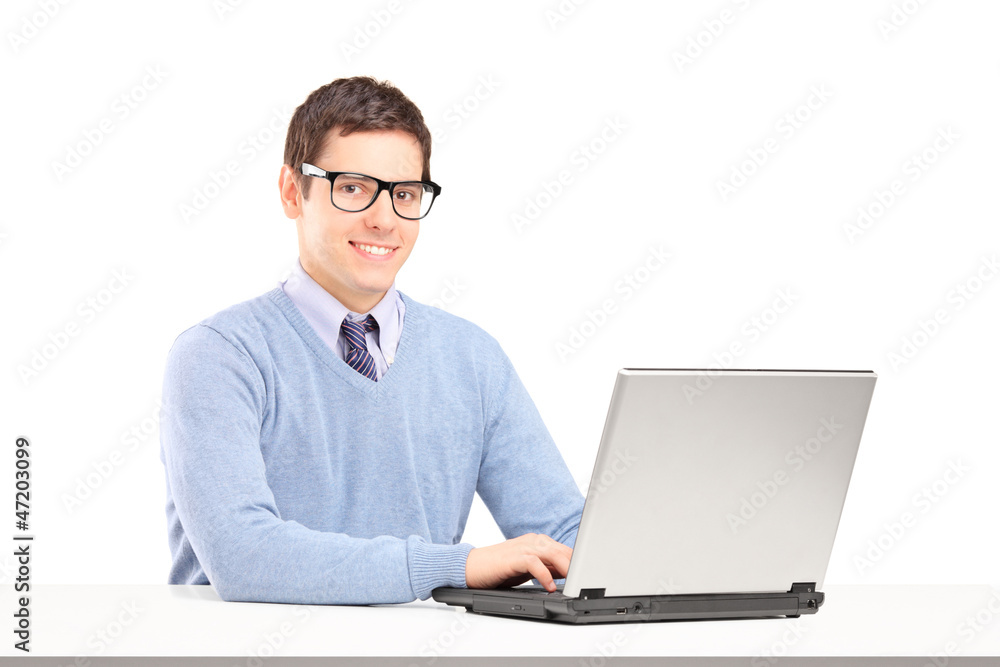 Smiling male working on a laptop Smiling male working on a laptop