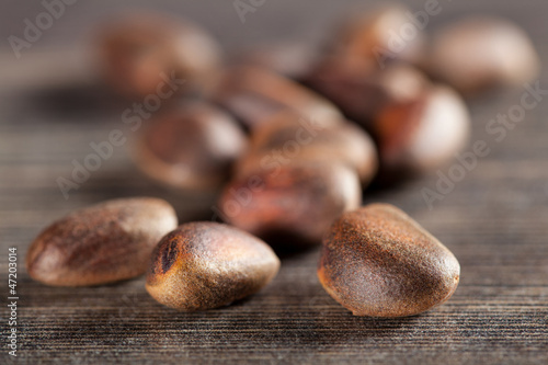 Cedar nuts on wooden table - closeup shot