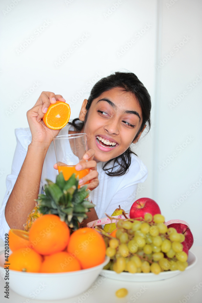 Beautiful girl holding fruits and a measure tape Beautiful girl holding fruits and a measure tape