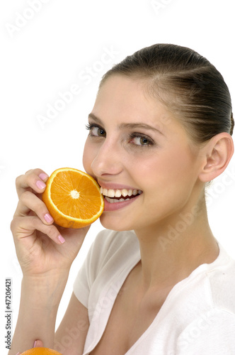 Close up young woman about to eat orange
