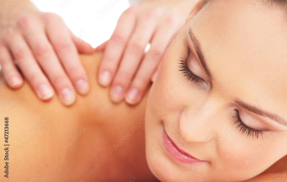 A young woman laying on a spa massage procedure