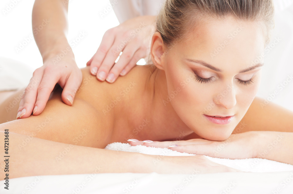 A young woman laying on a spa massage procedure