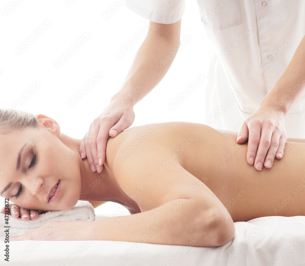 A young woman laying on a spa massage procedure A young woman laying on a spa massage procedure
