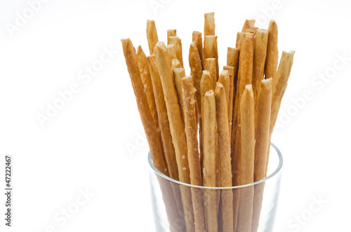 Bread sticks with salt in a glass beaker isolated closeup