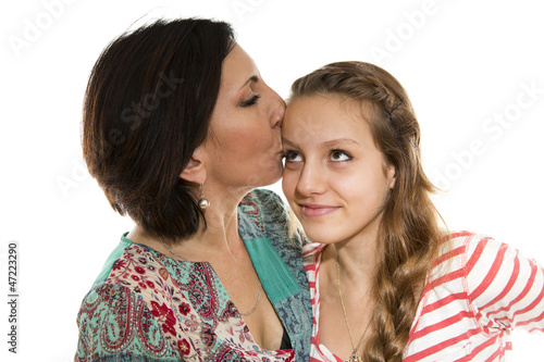 Mother kisses daughter