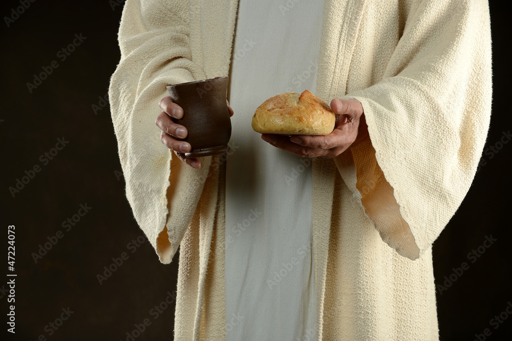Jesus holding bread and a cup of wine - obrazy, fototapety, plakaty 