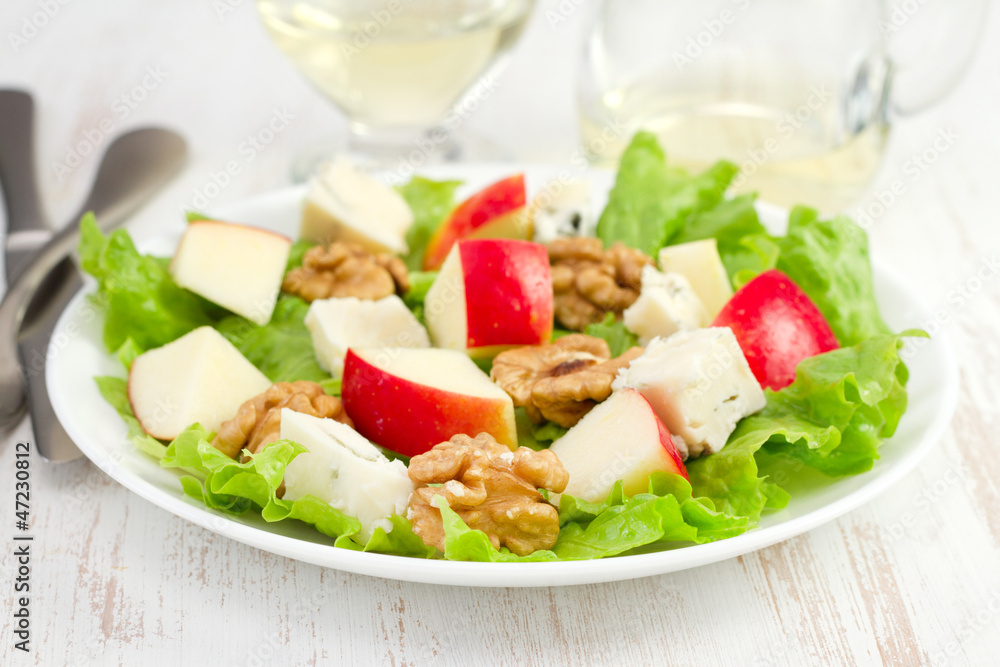 cheese salad with nuts and apple on the plate