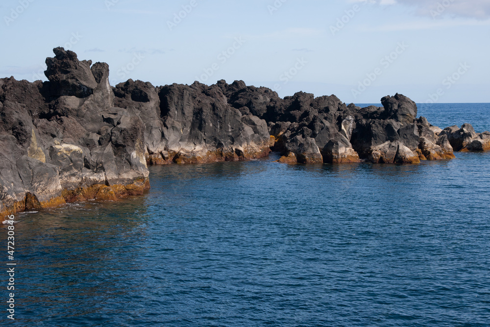 view in ocean and black stones in Azores