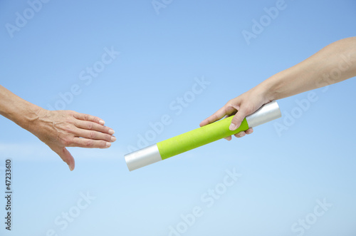 Isolated athletes hands with baton