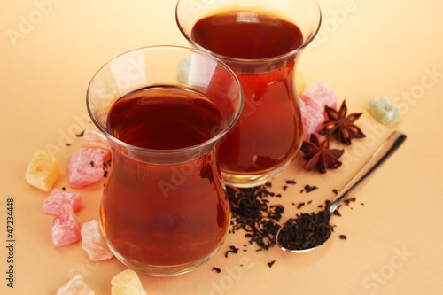 glasses of Turkish tea and rahat Delight, on beige background