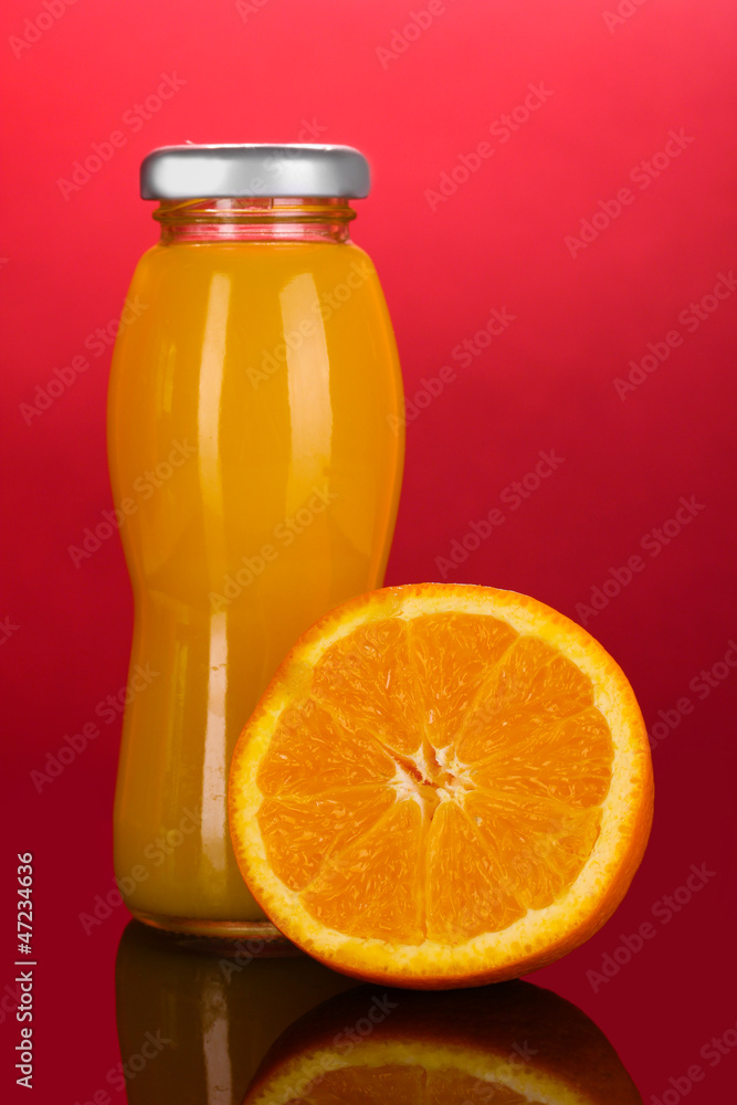 Delicious orange juice in a bottle and orange next to it Delicious orange juice in a bottle and orange next to it