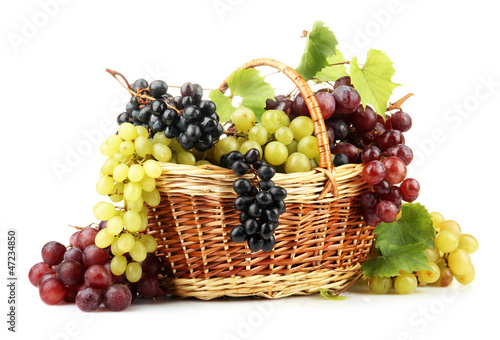 assortment of ripe sweet grapes in basket  isolated on white.