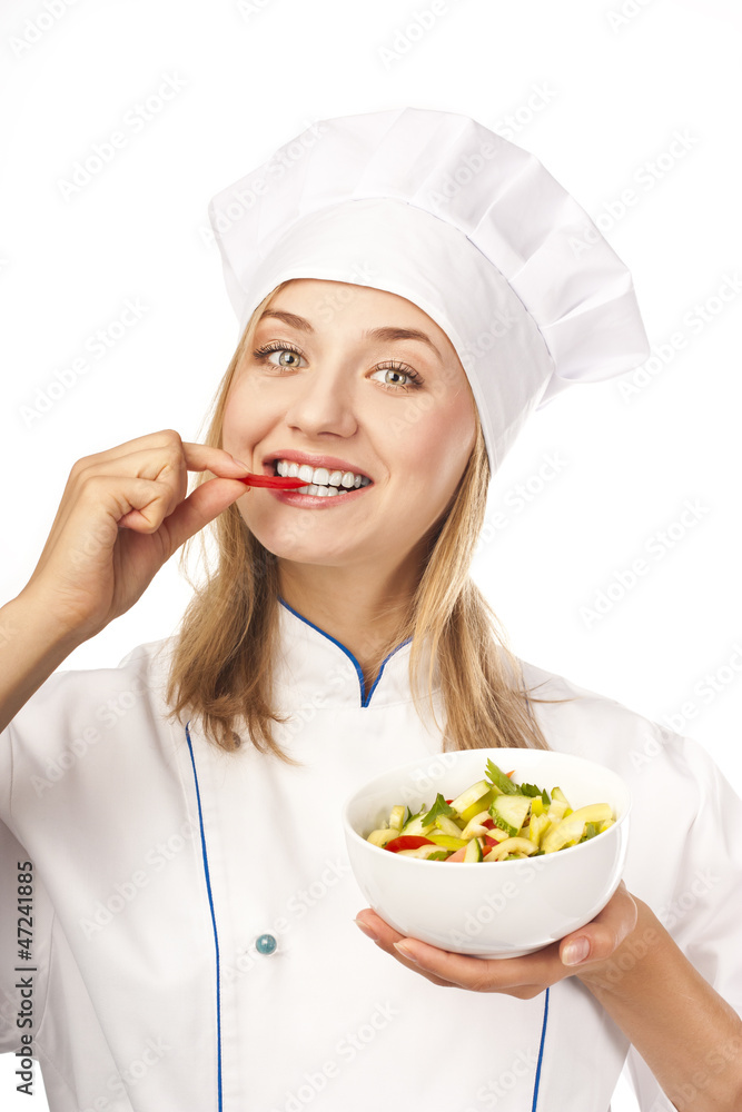Young chef taste salad. Studio white