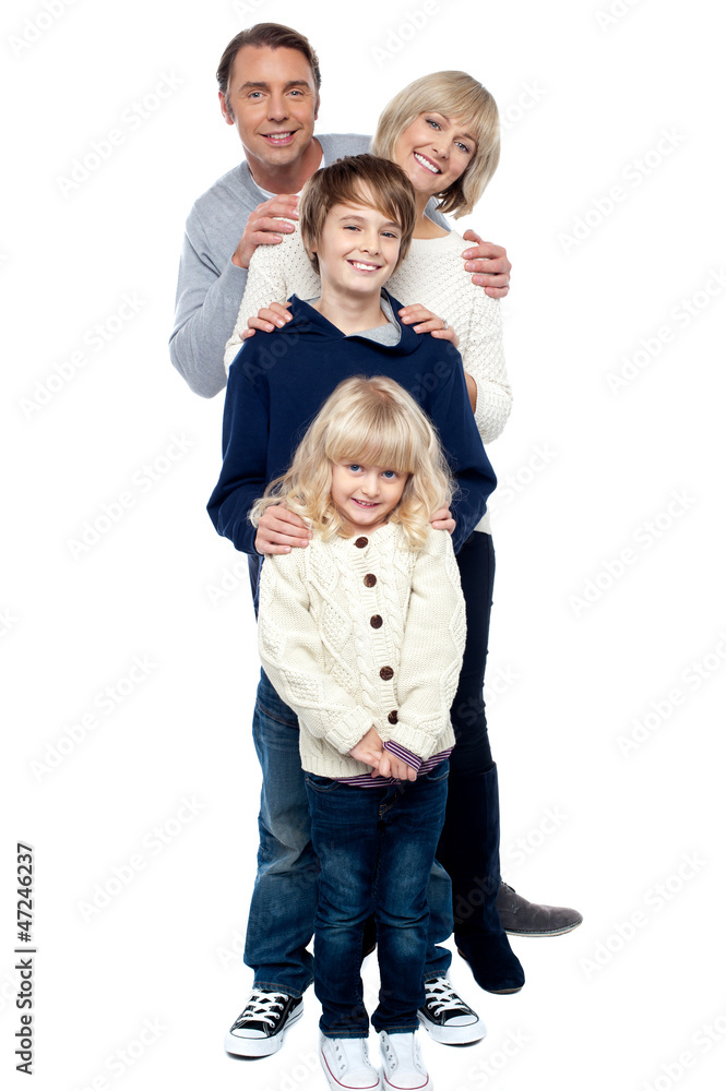 Affectionate family of four standing in a row Affectionate family of four standing in a row