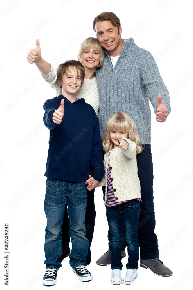 Adorable family in winter clothes gesturing thumbs up Adorable family in winter clothes gesturing thumbs up