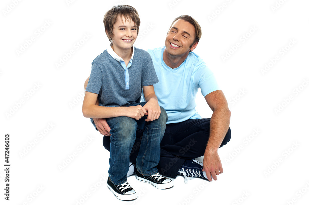 Affectionate father admiring his sweet son on his lap Affectionate father admiring his sweet son on his lap