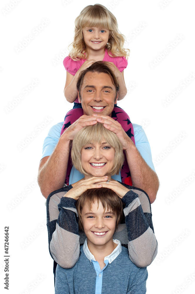 Attractive smiling family of four posing in a single line