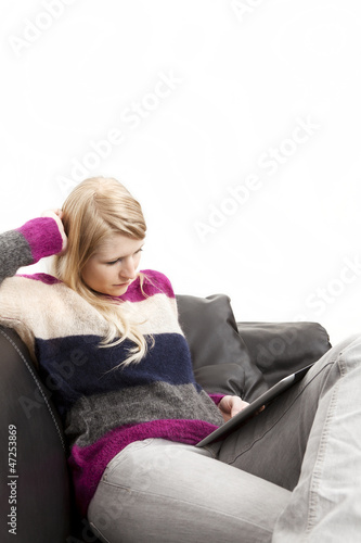 Frau in Freizeitkleidung blickt auf Tablet PC