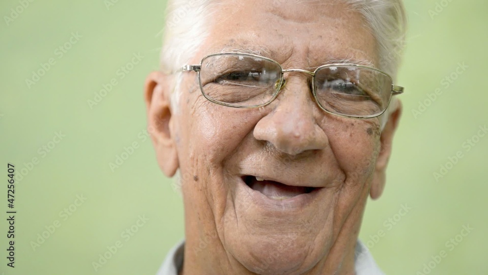 Happy old people, elderly man with eyeglasses smiling at camera Happy old people, elderly man with eyeglasses smiling at camera