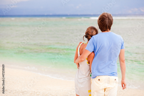 beautiful young couple looking on the horizon. honeymoom